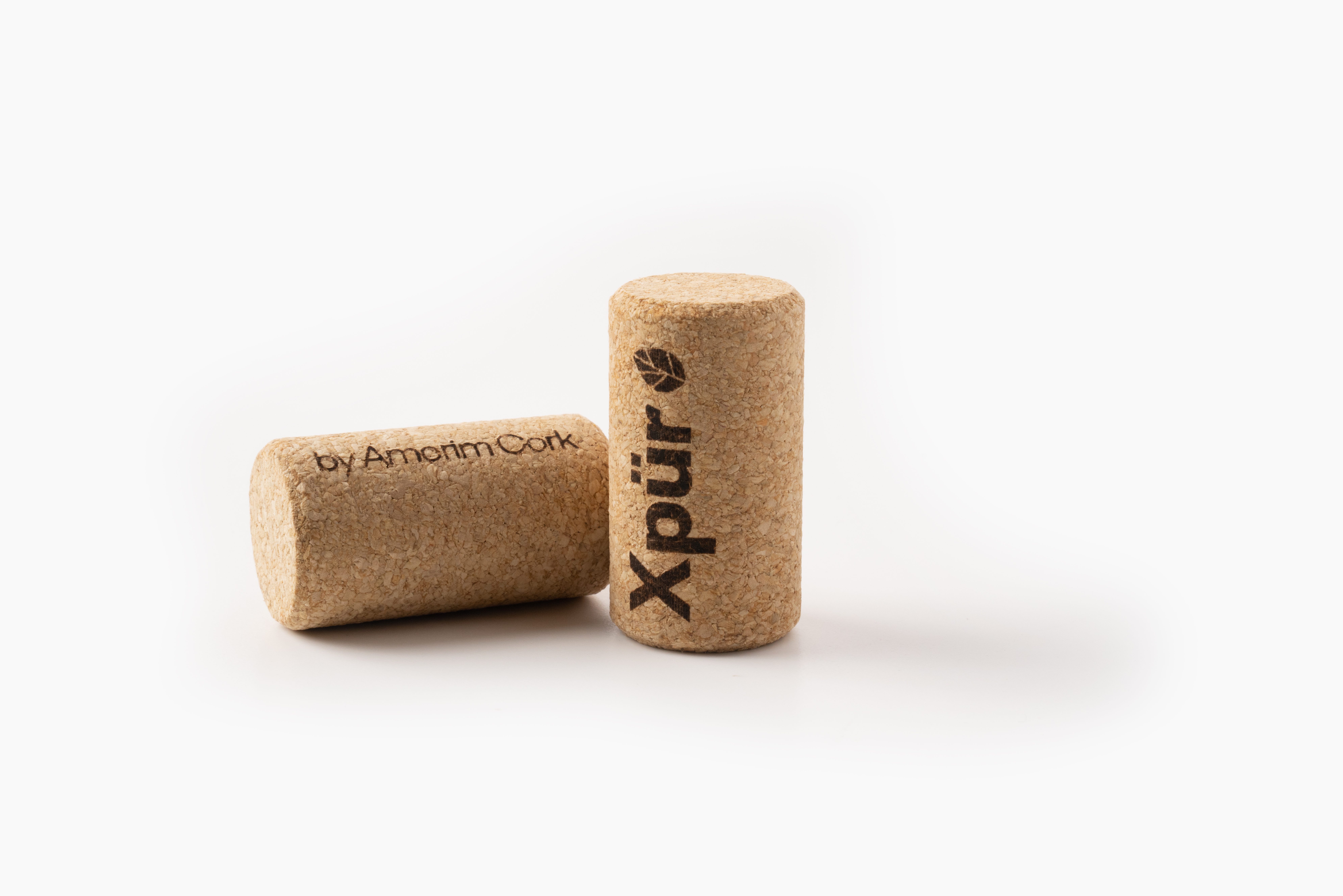 Close-up of Amorim's XPUR natural cork stopper, showcasing its smooth texture and uniform surface, designed for optimal performance in sealing wine bottles.